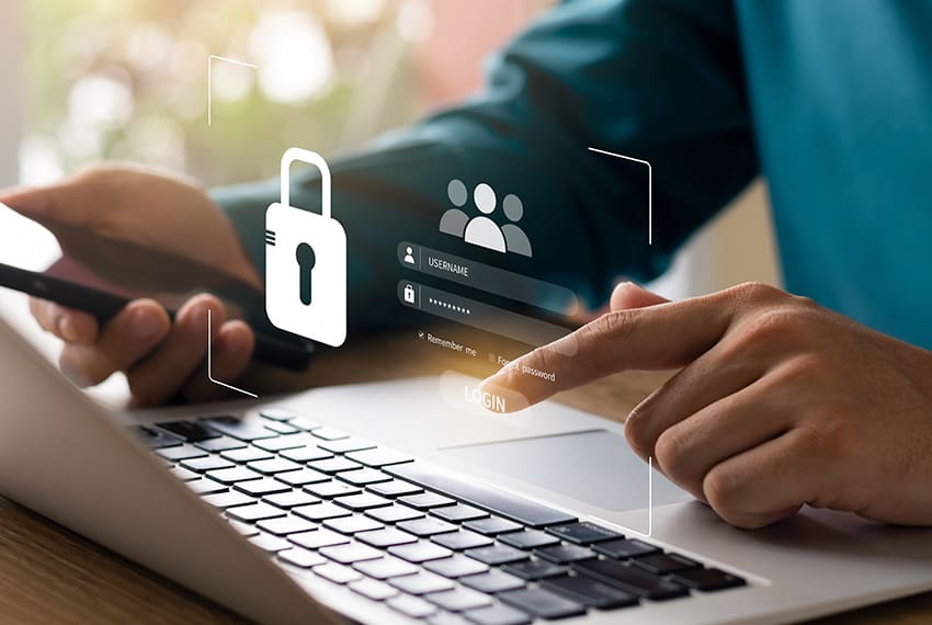 Person using laptop for password entry, featuring digital lock icon and login interface, emphasizing secure password management and digital security.