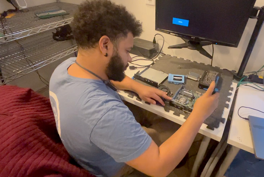 Technician repairing computer components on workspace, focusing on motherboard and hardware upgrades, illustrating expert computer repair services in Monmouth County.